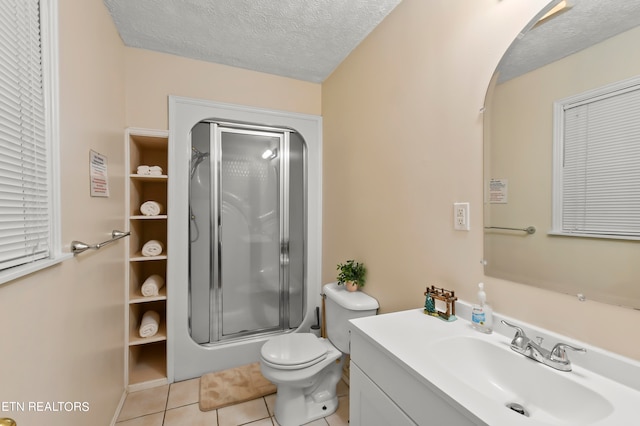 bathroom featuring vanity, tile patterned flooring, toilet, a textured ceiling, and an enclosed shower