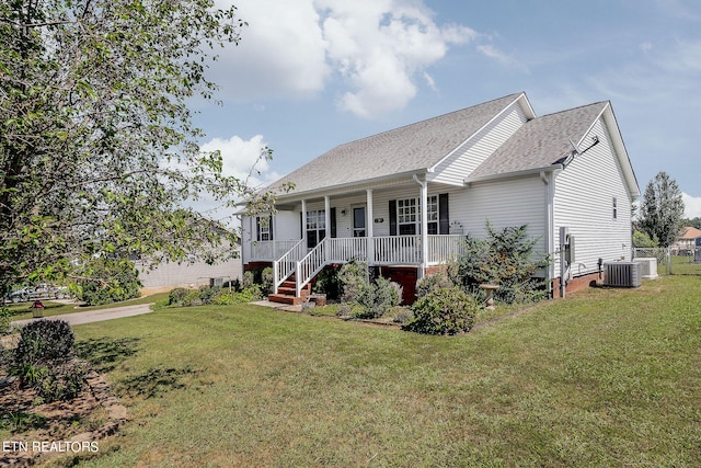 view of front of house with central AC unit, covered porch, and a front yard