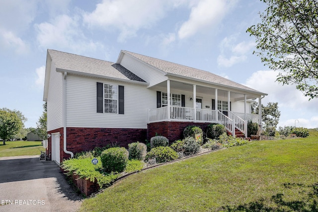 view of front facade with a front yard, a porch, and a garage