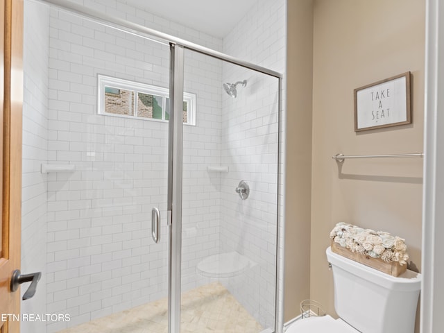 bathroom with an enclosed shower and toilet