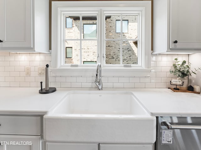 kitchen featuring white cabinets, sink, and stainless steel dishwasher