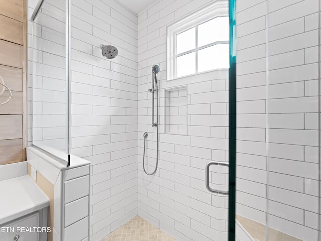 bathroom featuring vanity and an enclosed shower