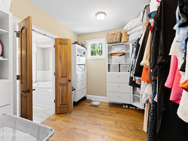 walk in closet featuring light hardwood / wood-style floors