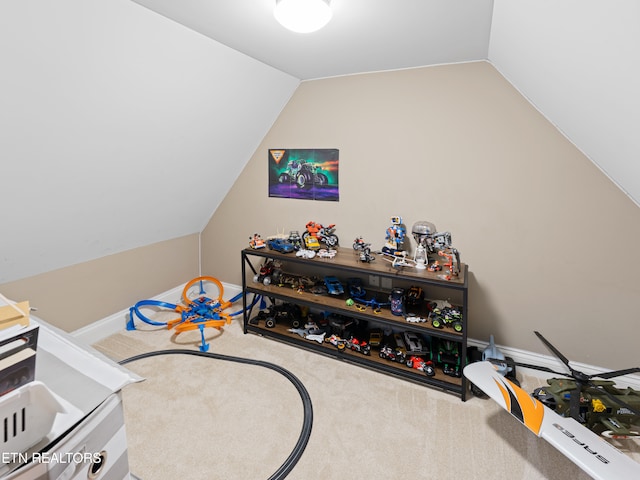 rec room featuring carpet and vaulted ceiling