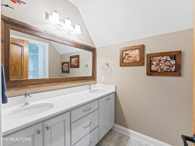 bathroom with vanity and vaulted ceiling