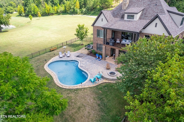 view of pool with a patio area and a lawn