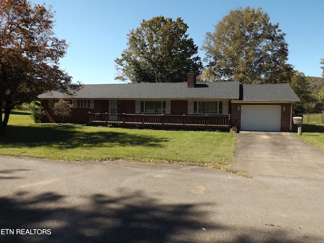 single story home with a front yard and a garage