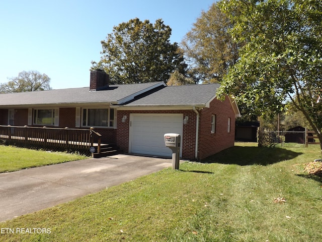 ranch-style house with a garage, a deck, and a front yard