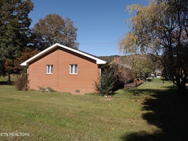 view of property exterior with a yard