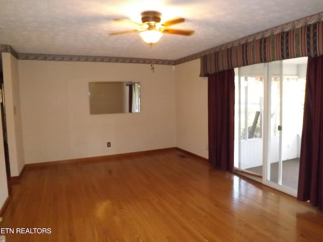 spare room with a textured ceiling, hardwood / wood-style flooring, and ceiling fan