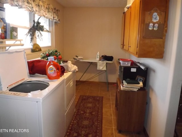 washroom with washer and clothes dryer, light tile patterned floors, and cabinets