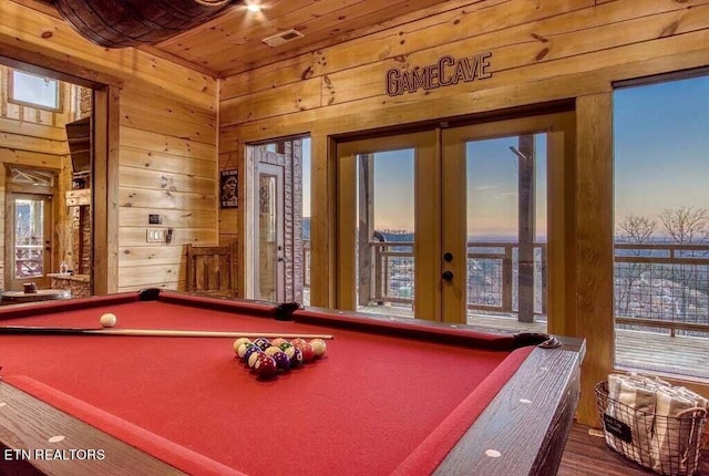 rec room featuring billiards, wood ceiling, wooden walls, and french doors