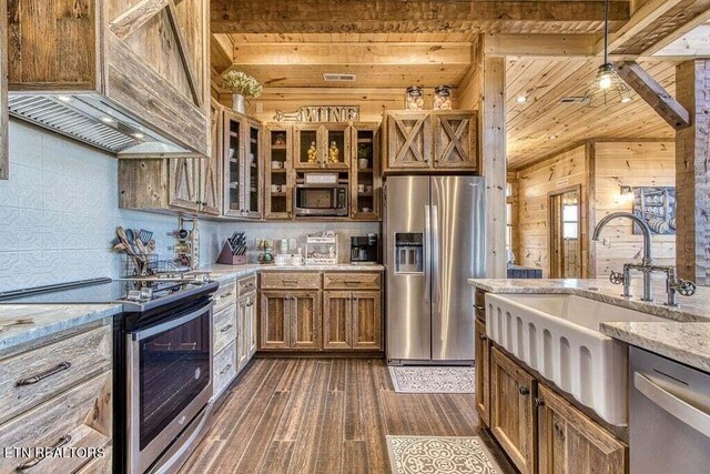 kitchen with wooden ceiling, light stone countertops, stainless steel appliances, premium range hood, and dark wood-type flooring