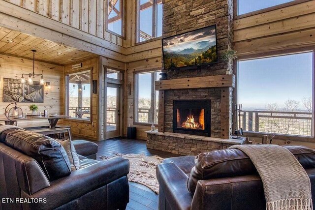 living room with wood walls, hardwood / wood-style flooring, a fireplace, and wooden ceiling