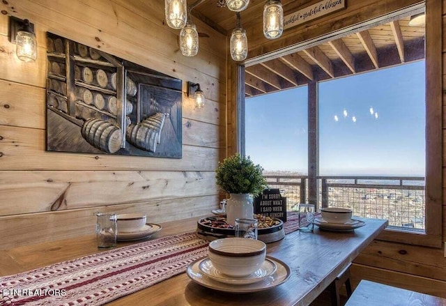 interior space with wood walls, wood-type flooring, and a water view