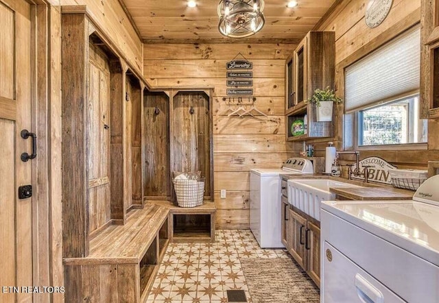 interior space featuring wood ceiling, washer and dryer, and wooden walls