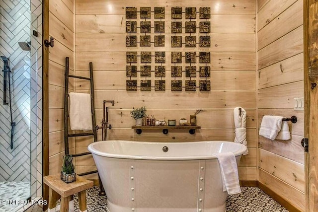 bathroom featuring tile patterned flooring, wood walls, and a bathing tub