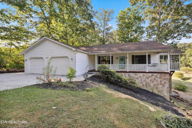 ranch-style house featuring a garage, a front lawn, and covered porch