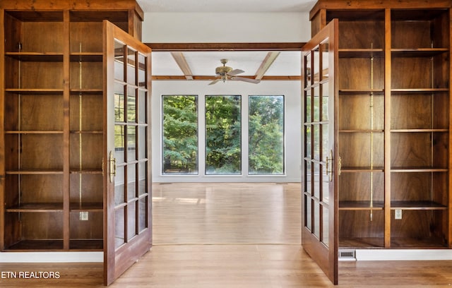 interior space featuring light hardwood / wood-style flooring, ceiling fan, beamed ceiling, and french doors