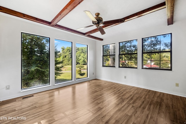 spare room featuring ceiling fan, beam ceiling, and hardwood / wood-style flooring