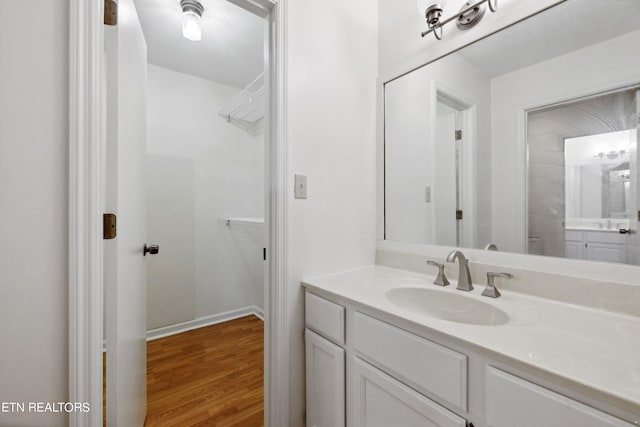 bathroom with hardwood / wood-style flooring and vanity