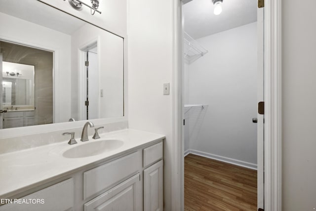 bathroom with vanity and hardwood / wood-style flooring