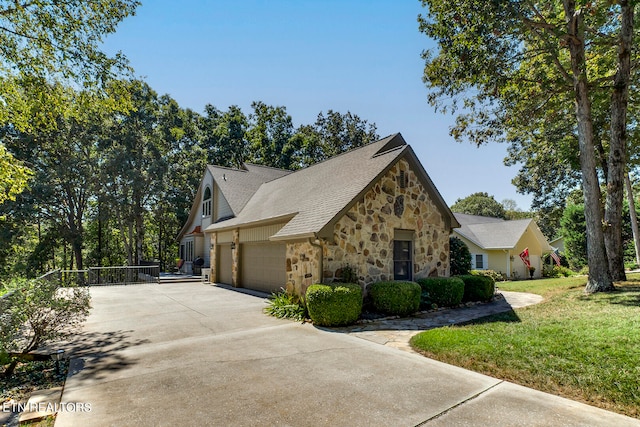 view of side of property with a garage and a yard