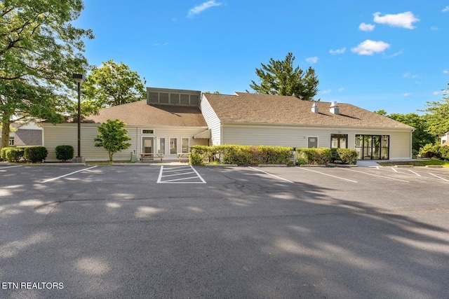 view of building exterior with uncovered parking