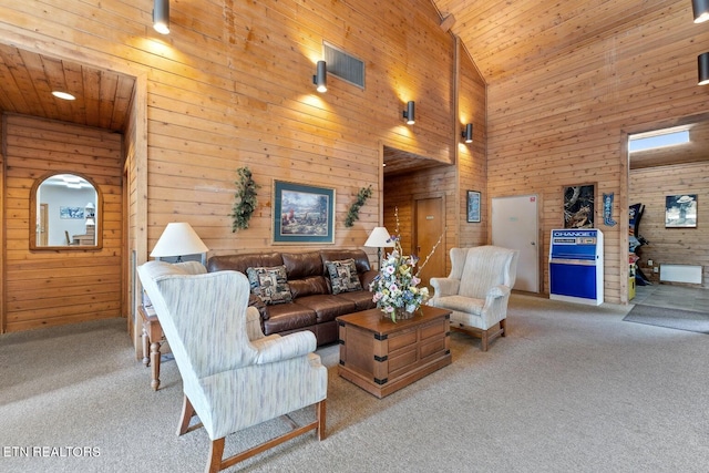 living room with light carpet, wood walls, high vaulted ceiling, and wooden ceiling