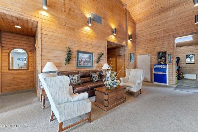 living room with high vaulted ceiling, wood walls, wood ceiling, and carpet floors