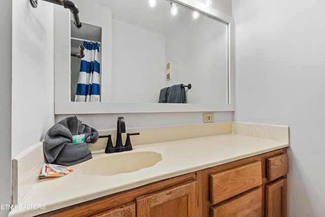 bathroom with track lighting and vanity