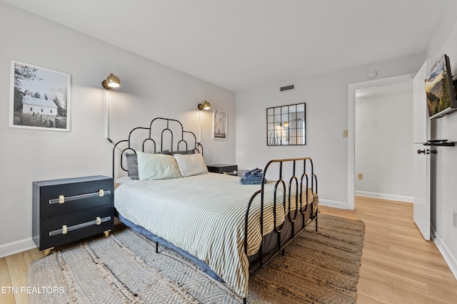 bedroom with hardwood / wood-style floors