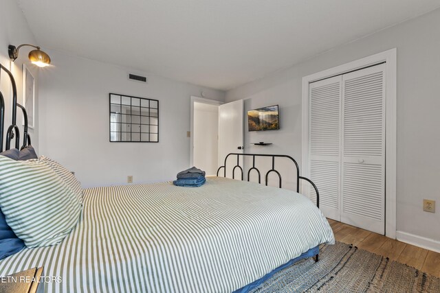 bedroom with hardwood / wood-style floors and a closet