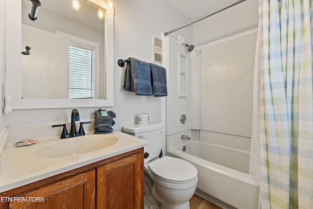 full bathroom with wood-type flooring, vanity, shower / tub combo, and toilet