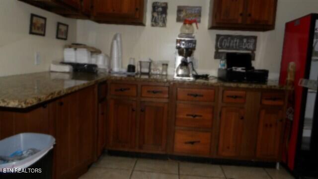 kitchen with light tile patterned flooring