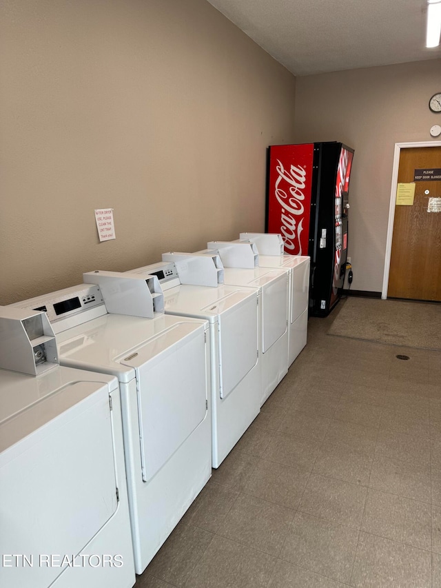 clothes washing area with washer and clothes dryer