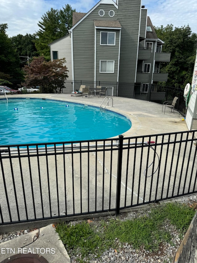 view of swimming pool with a patio area