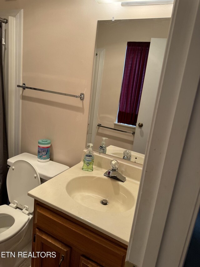 bathroom featuring vanity and toilet