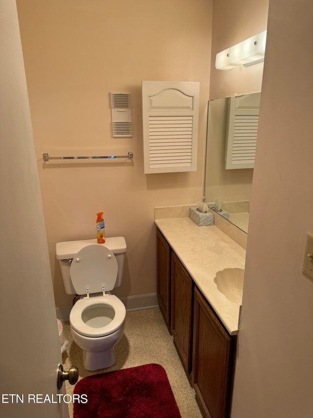 bathroom with toilet and vanity