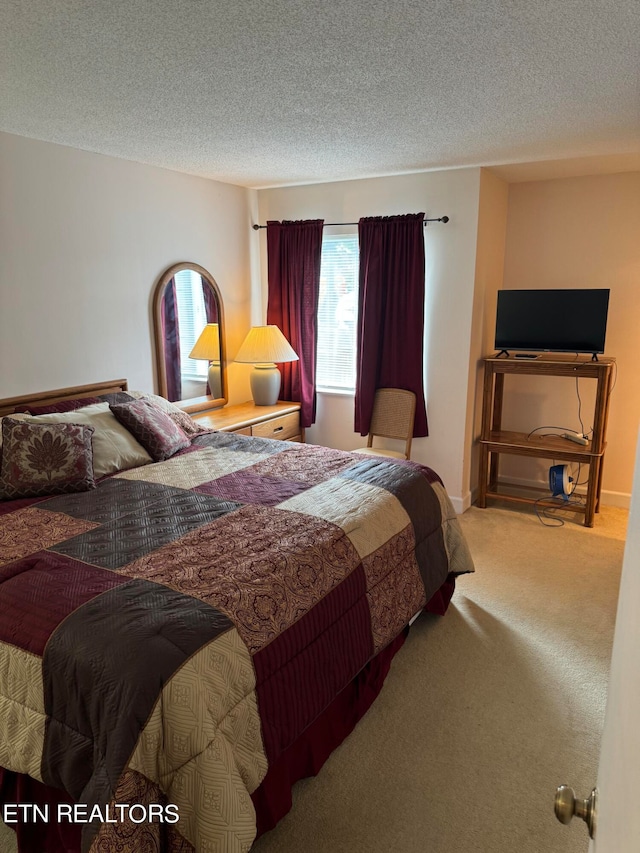 carpeted bedroom featuring a textured ceiling