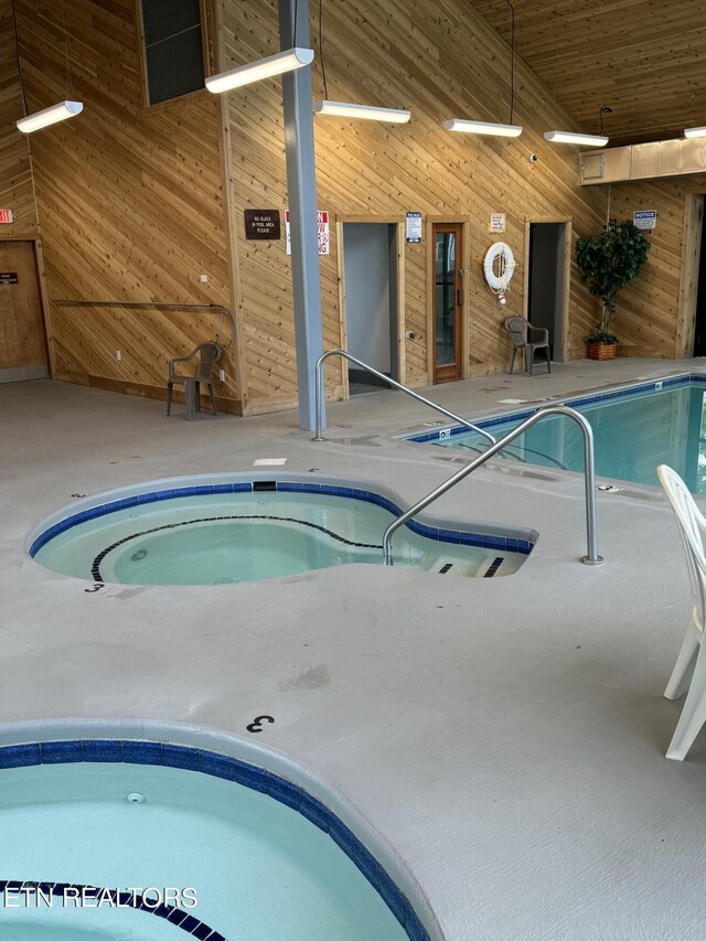 view of pool with an indoor hot tub