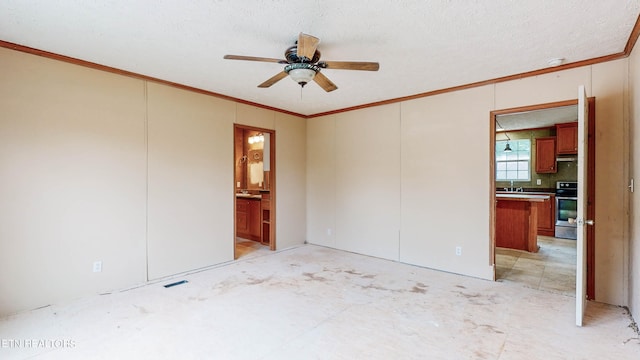 unfurnished bedroom featuring a textured ceiling, crown molding, ensuite bath, and ceiling fan