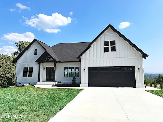 modern farmhouse featuring a garage, driveway, a front lawn, and board and batten siding