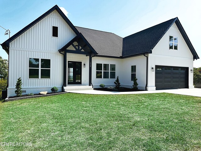 modern farmhouse style home featuring a garage and a front yard