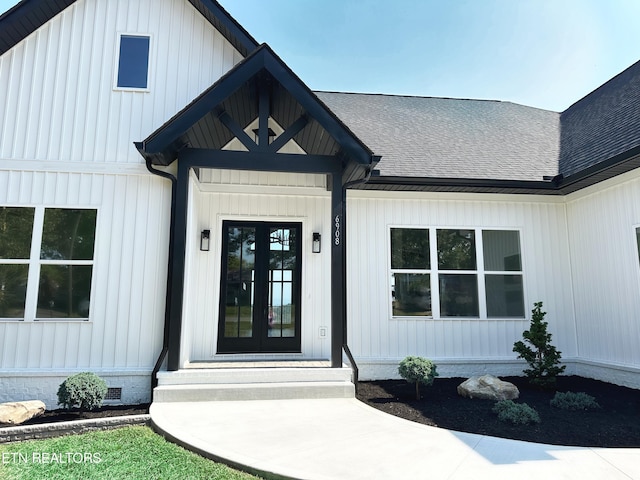 doorway to property featuring crawl space, a shingled roof, and board and batten siding