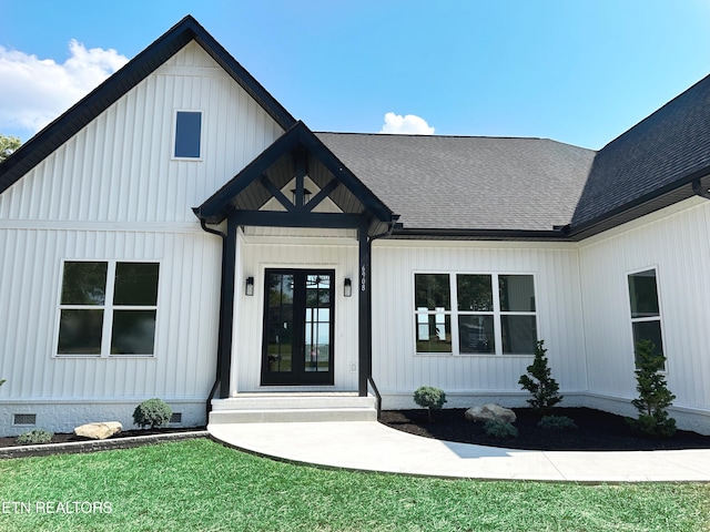 property entrance with roof with shingles, french doors, crawl space, and board and batten siding