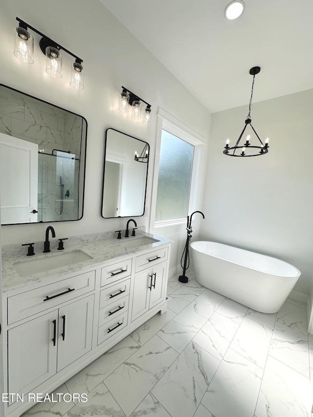 full bath with double vanity, marble finish floor, a shower stall, and a sink