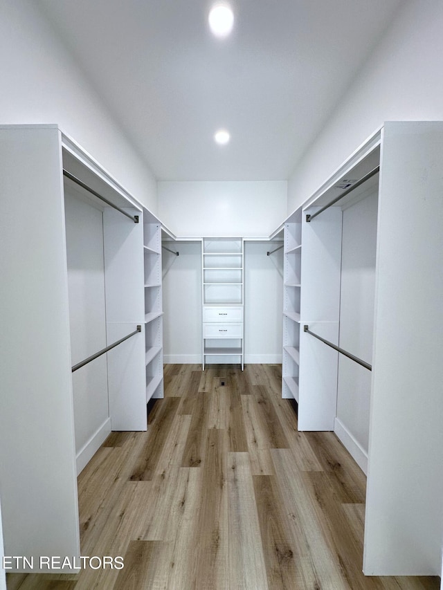 spacious closet featuring light wood-type flooring