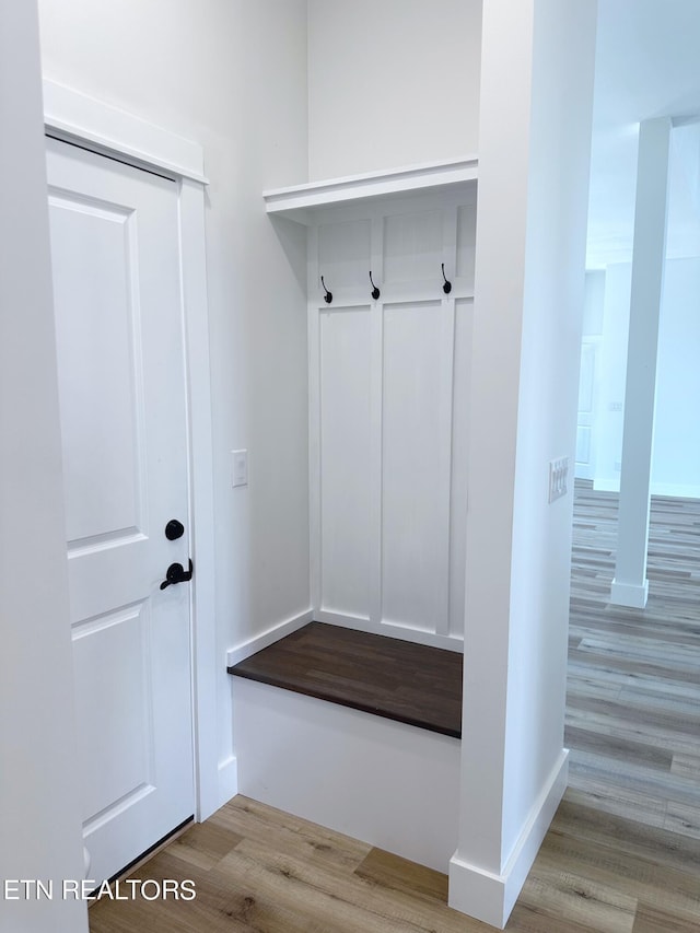 mudroom with baseboards and wood finished floors