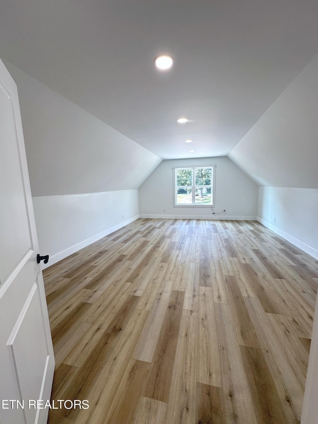 bonus room featuring vaulted ceiling, recessed lighting, baseboards, and light wood-style floors